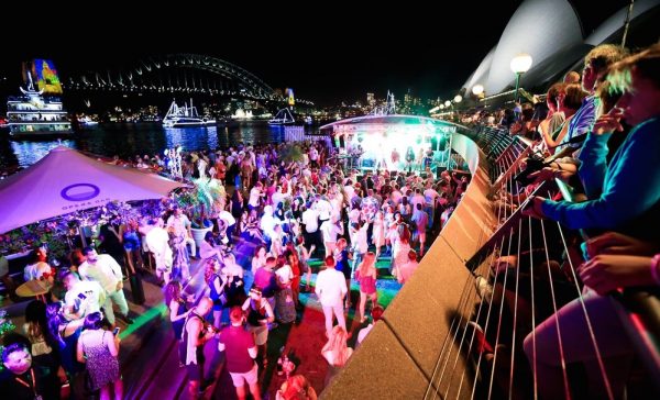 OPERA BAR Waterfront night party with colorful lights and Sydney Harbour landmarks.